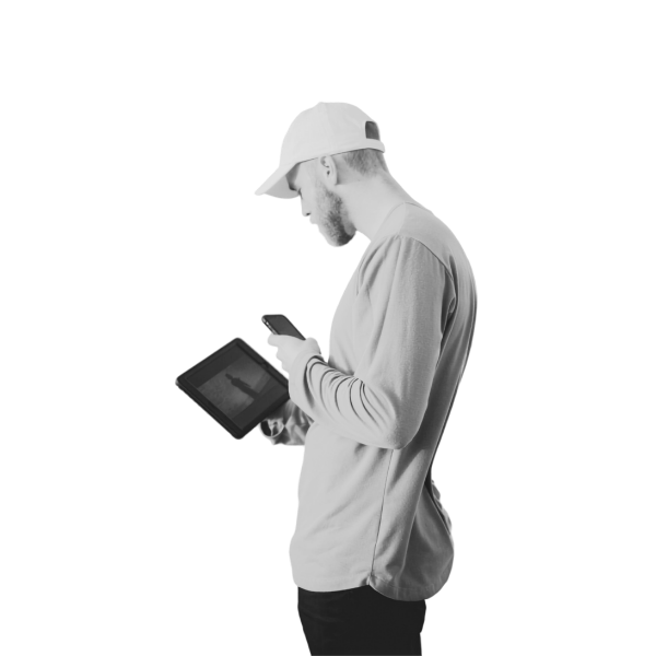 Man in a cap and hoodie holding a tablet